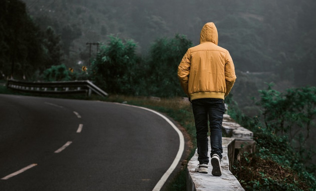 Turning a Walk Into a Spiritual Journey a man on a solitary walk on a path next to a paved road
